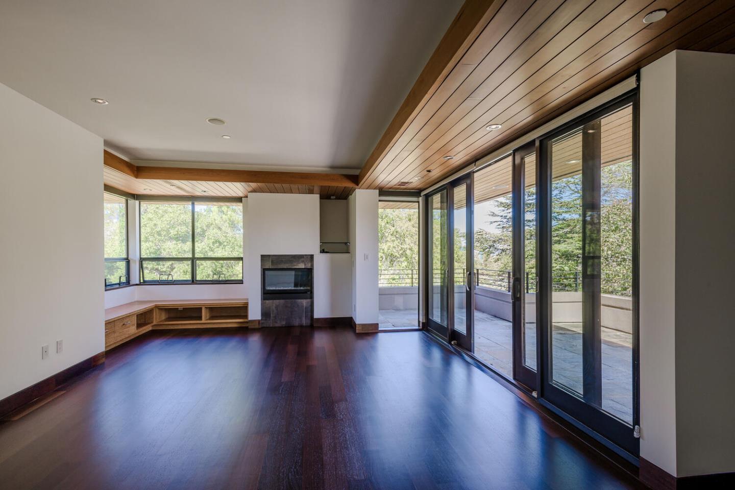 2510 Skyfarm Drive Hillsborough, CA 94010 - Photo 33 of 66 a view of empty room with wooden floor and fireplace