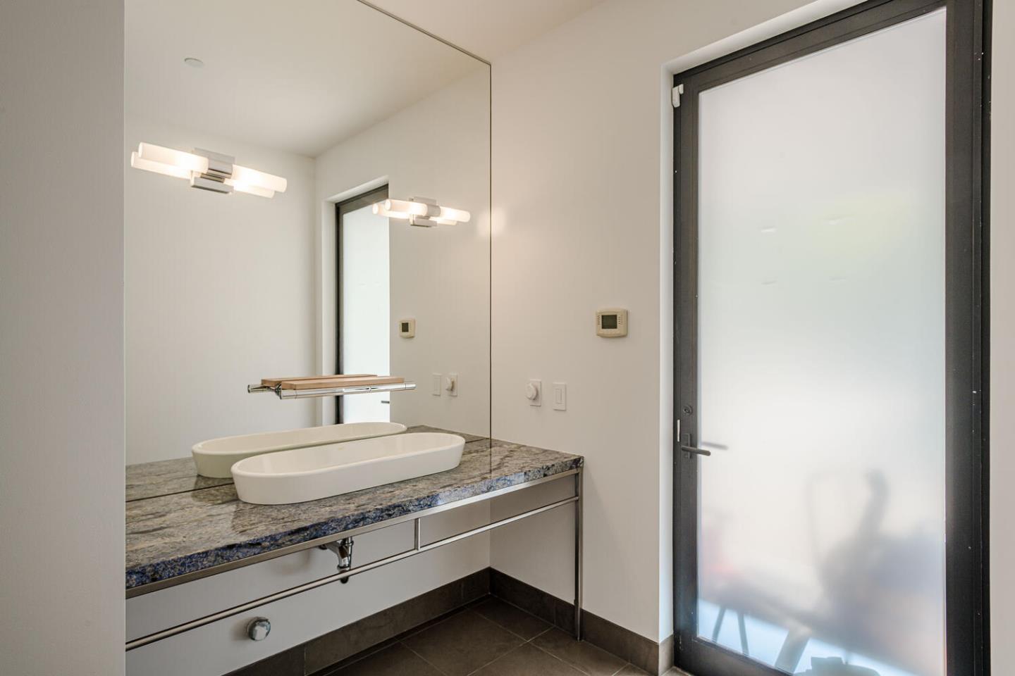 2510 Skyfarm Drive Hillsborough, CA 94010 - Photo 43 of 66 a bathroom with a granite countertop sink and a mirror