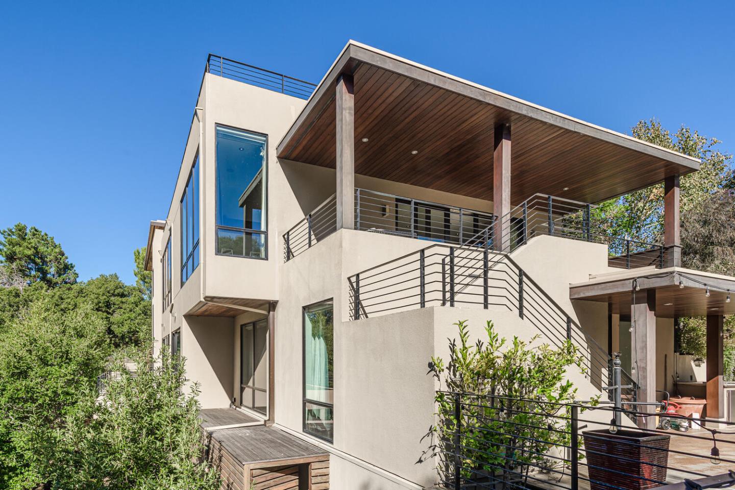 2510 Skyfarm Drive Hillsborough, CA 94010 - Photo 59 of 66 a view of a white house with a large window and potted plants