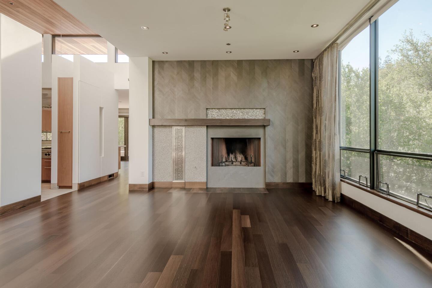 2510 Skyfarm Drive Hillsborough, CA 94010 - Photo 8 of 66 an empty room with wooden floor and a fireplace