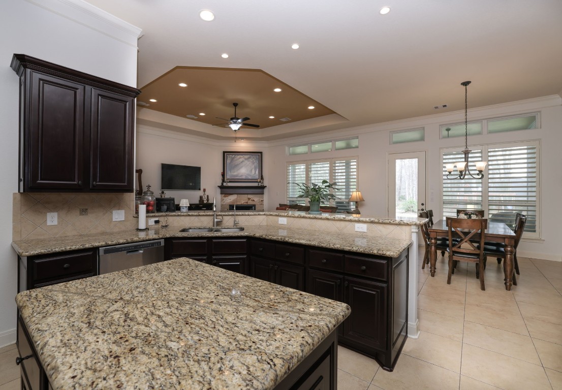 1547 Ruby Drive Willis, TX 77378 - Photo 19 of 45 a kitchen with a sink and chairs