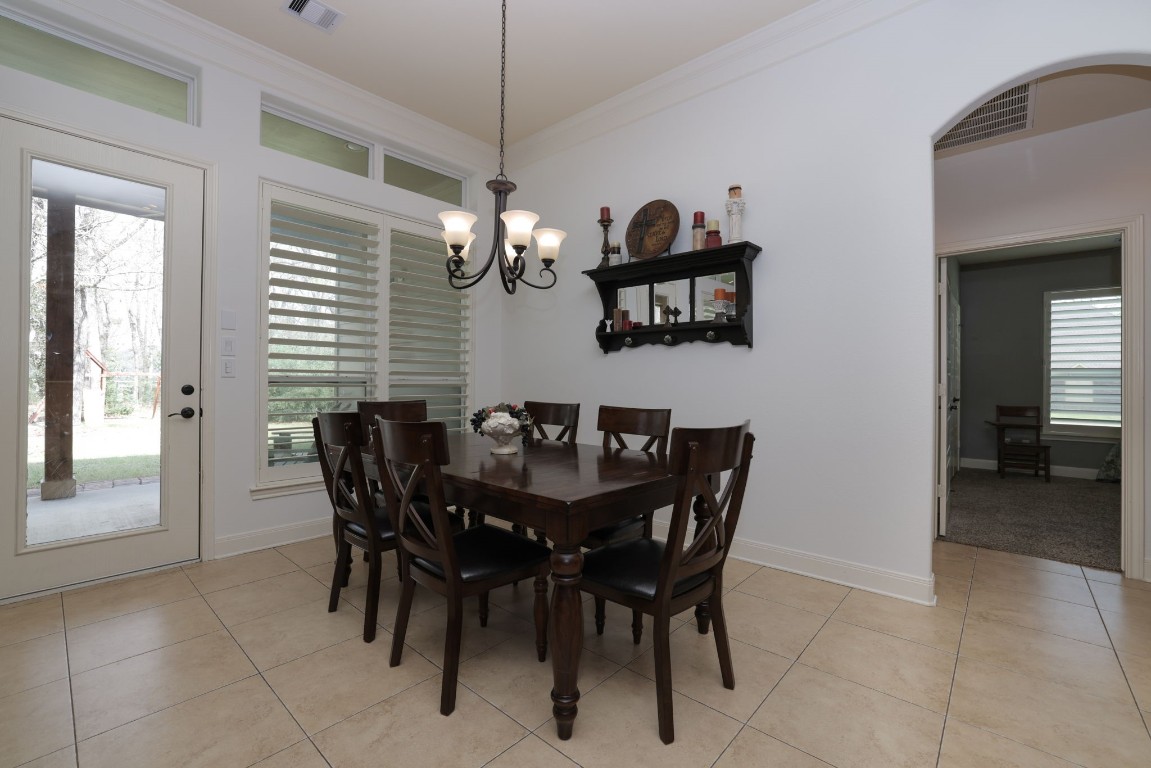 1547 Ruby Drive Willis, TX 77378 - Photo 20 of 45 a view of a dining room with furniture and chandelier