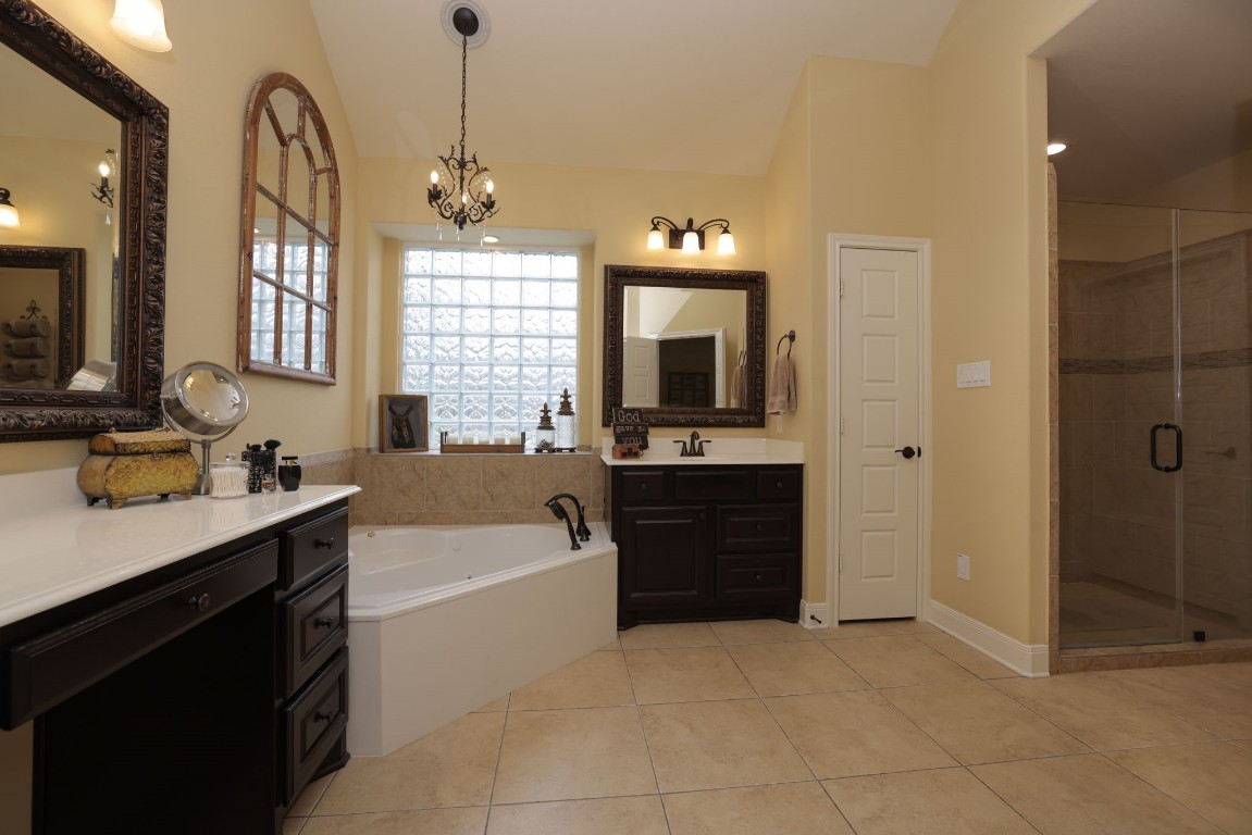 1547 Ruby Drive Willis, TX 77378 - Photo 24 of 45 a bathroom with a tub sink and mirror