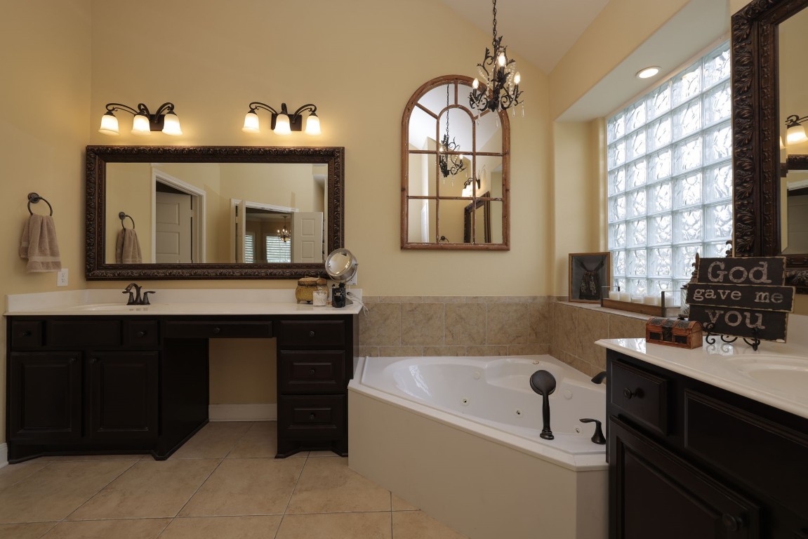 1547 Ruby Drive Willis, TX 77378 - Photo 25 of 45 a bathroom with a tub sink and mirror