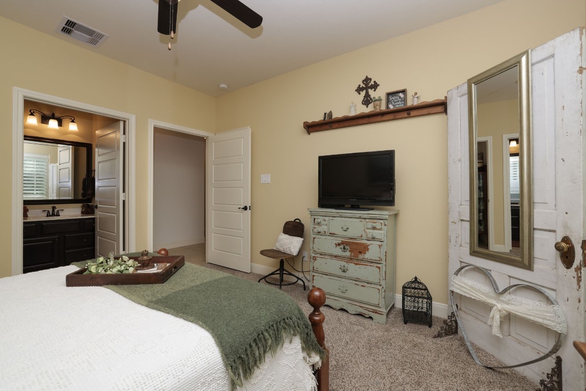 1547 Ruby Drive Willis, TX 77378 - Photo 28 of 45 a bedroom with a bed and a flat tv screen on wall