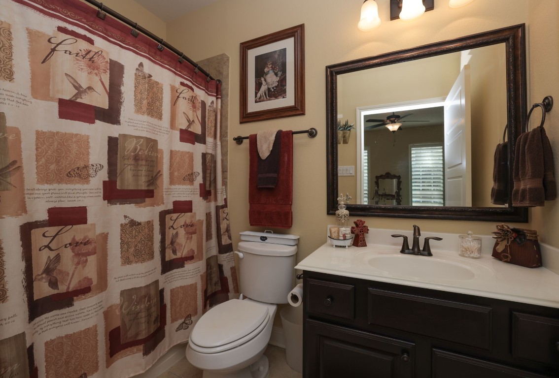 1547 Ruby Drive Willis, TX 77378 - Photo 29 of 45 a bathroom with a granite countertop toilet sink and a mirror