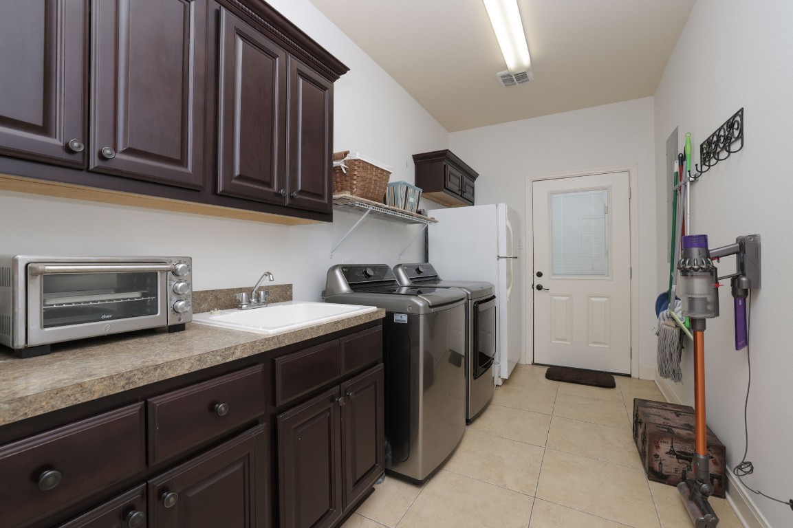 1547 Ruby Drive Willis, TX 77378 - Photo 31 of 45 a kitchen with stainless steel appliances granite countertop a sink stove and cabinets