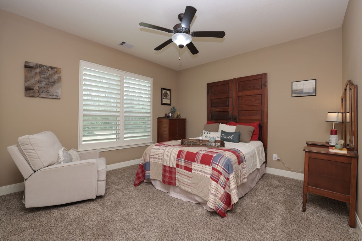 1547 Ruby Drive Willis, TX 77378 - Photo 36 of 45 a bed room with bed and a couch