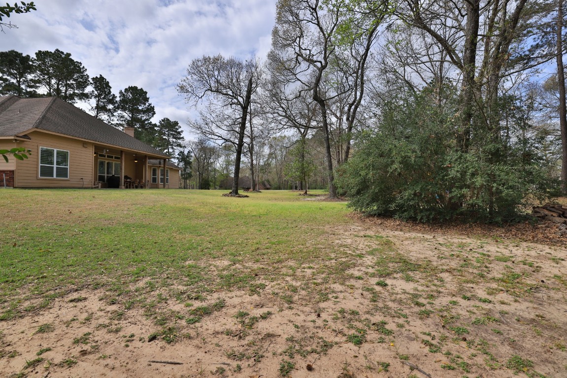 1547 Ruby Drive Willis, TX 77378 - Photo 40 of 45 a backyard of a house with lots of green space