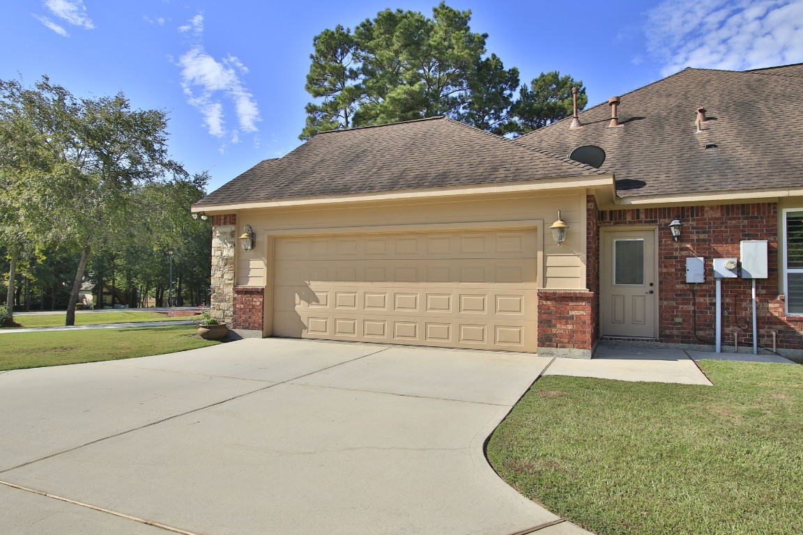 1547 Ruby Drive Willis, TX 77378 - Photo 45 of 45 a front view of a house with a yard and garage