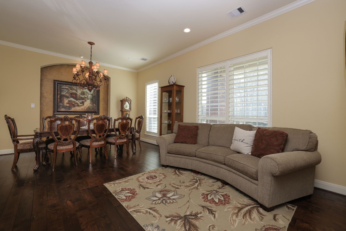 1547 Ruby Drive Willis, TX 77378 - Photo 10 of 45 a living room with furniture and a chandelier
