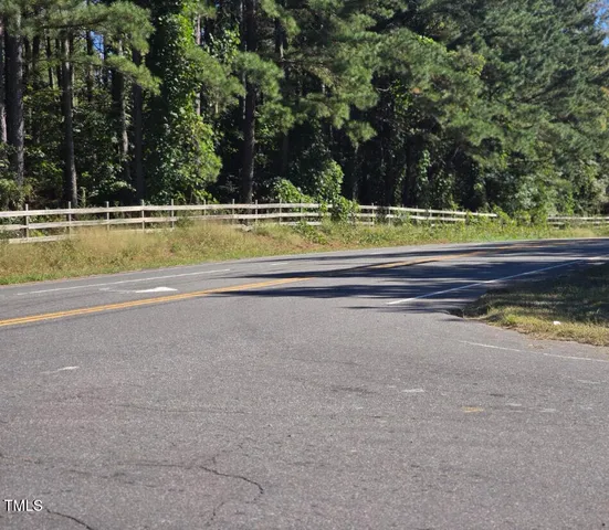 a view of a swimming pool with a large trees