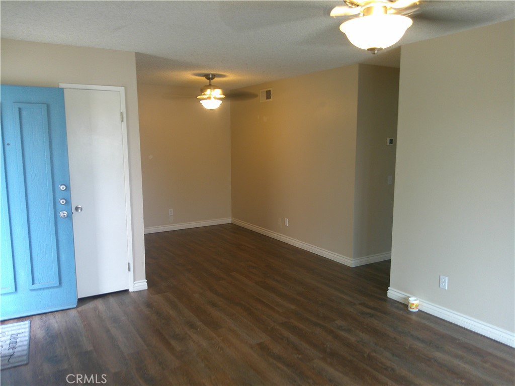 8990 19th Street, Unit 286 Rancho Cucamonga, CA 91701 - Photo 3 of 10 wooden floor in an empty room with a mirror