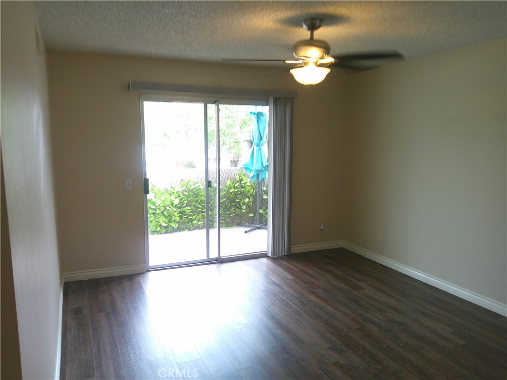 8990 19th Street, Unit 286 Rancho Cucamonga, CA 91701 - Photo 9 of 10 a view of an empty room with wooden floor and a window