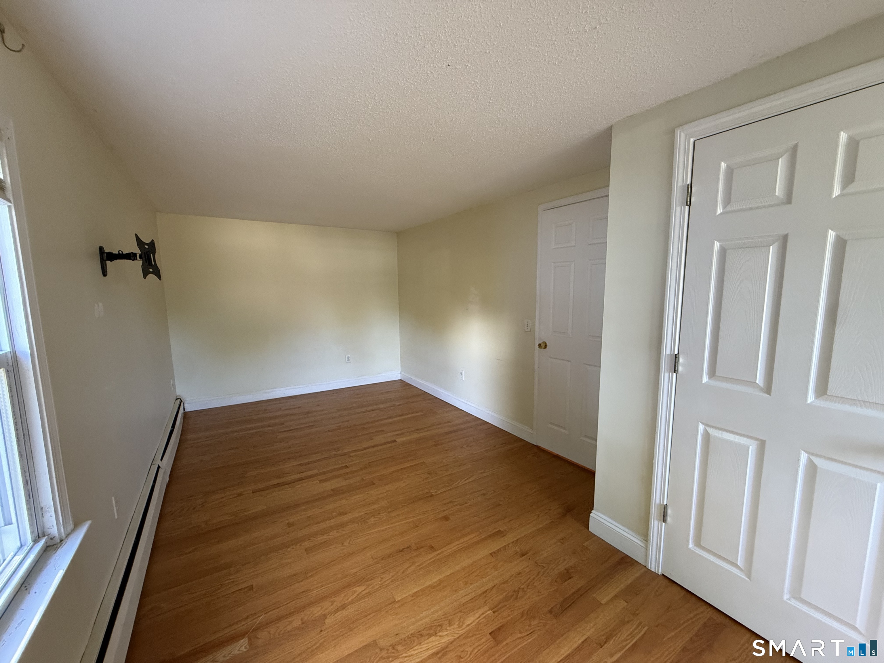 808 East Main Street Torrington, CT 06790 - Photo 37 of 40 an empty room with wooden floor and entrance