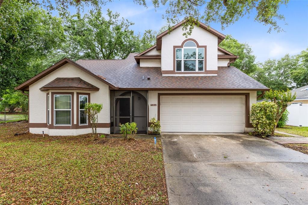 a front view of a house with a garden and yard