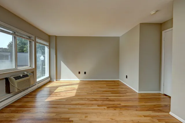 a view of a room with wooden floor and bathroom
