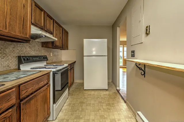 a kitchen with stainless steel appliances granite countertop wooden cabinets a stove a sink and dishwasher
