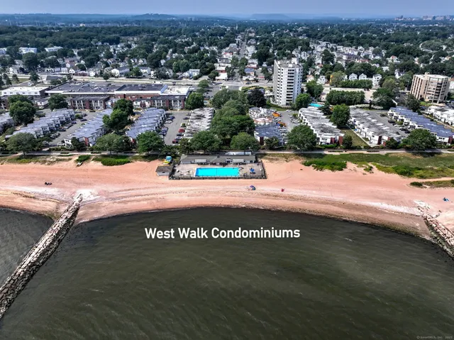 an aerial view of a swimming pool with outdoor seating