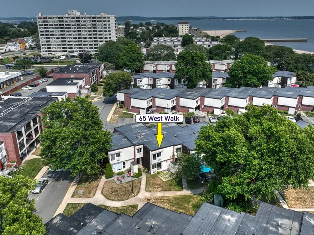 an aerial view of a house with garden space and street view