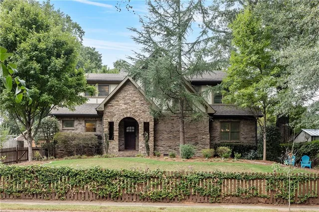 a front view of a house with a garden