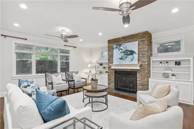 a living room with furniture large window and fireplace