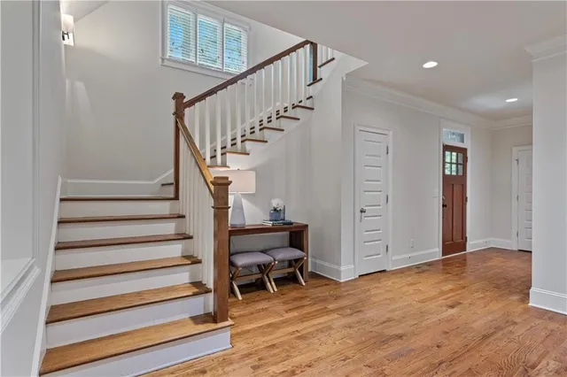 a view of entryway with wooden floor and stairs