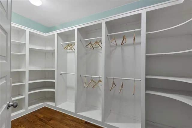 a view of walk in closet with empty racks