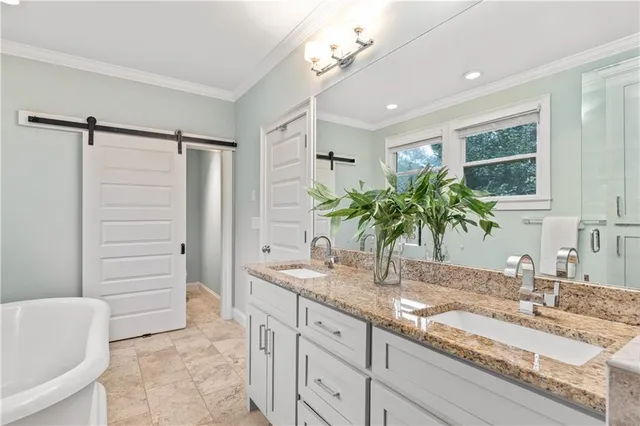 a bathroom with a sink and mirror with bathtub