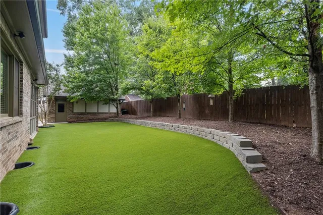 a view of a house with wooden fence