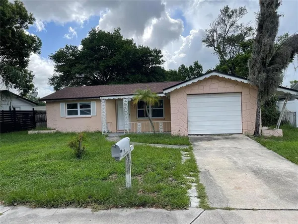 a front view of house with yard and green space