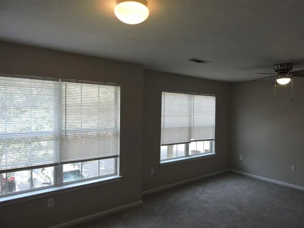 a view of empty room with a chandelier fan