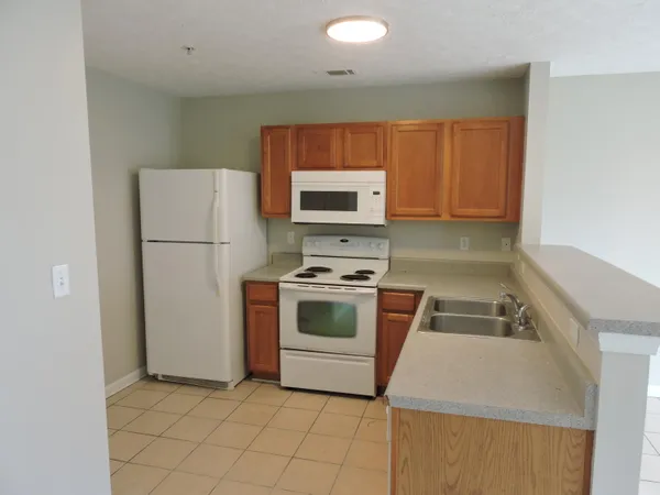 a kitchen with a stove and a refrigerator