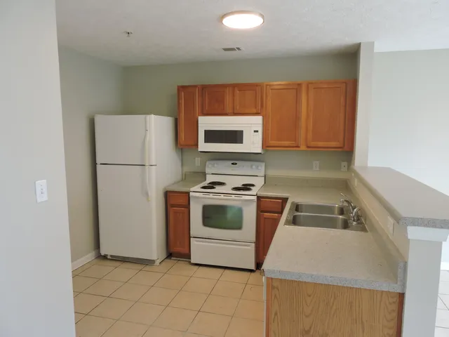 a kitchen with a stove and a refrigerator