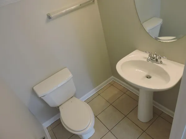 a bathroom with a sink toilet and a mirror
