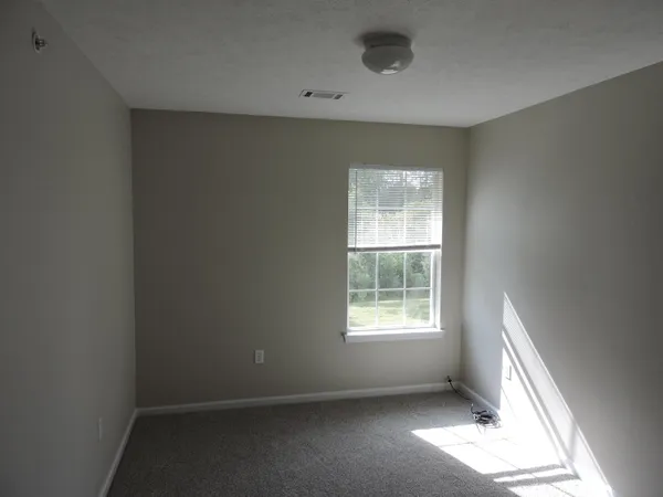 a view of an empty room and a sink