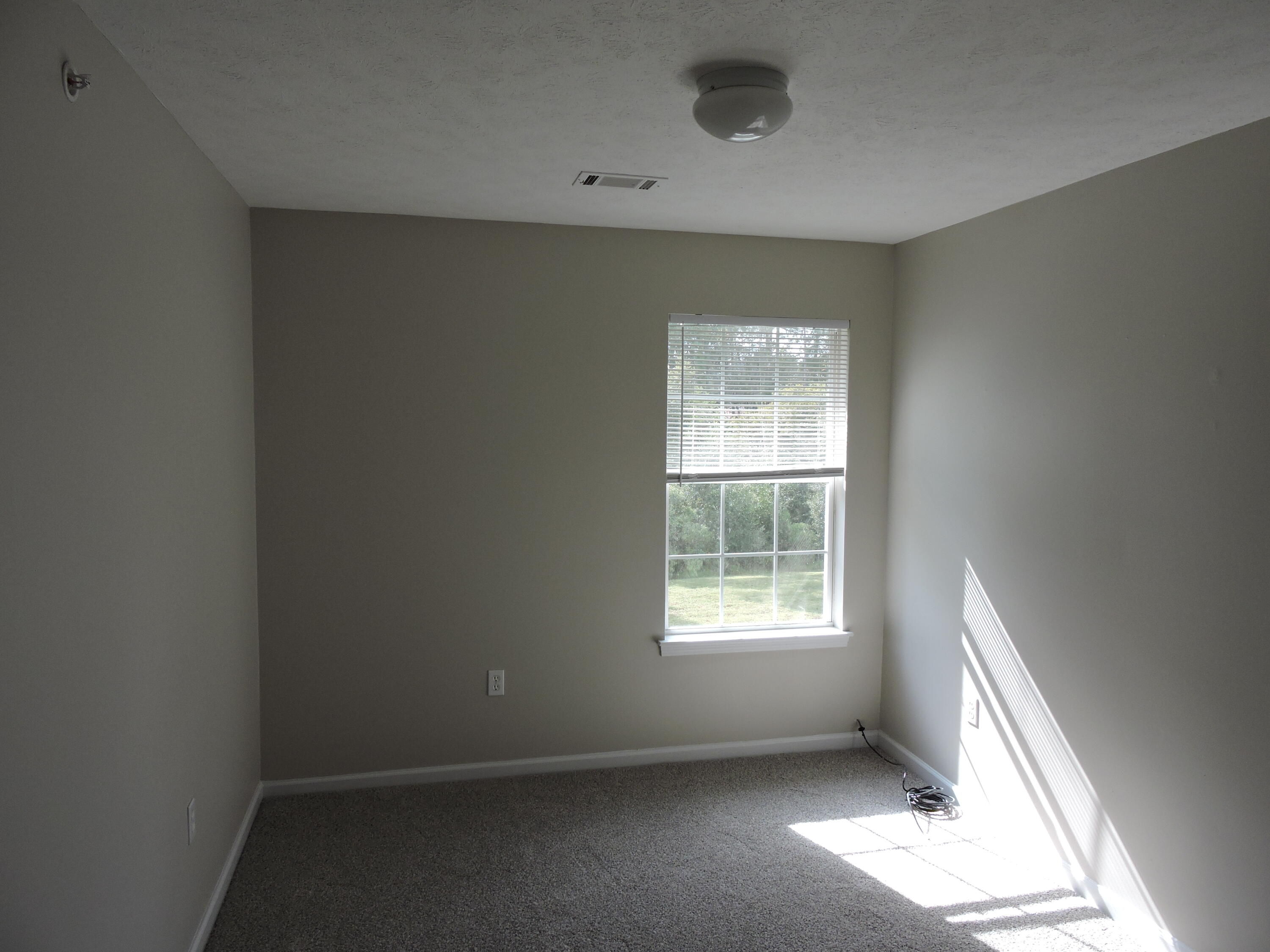 207 Swaying Pine Court Crestview, FL 32539 - Photo 7 of 15 an empty room with a window