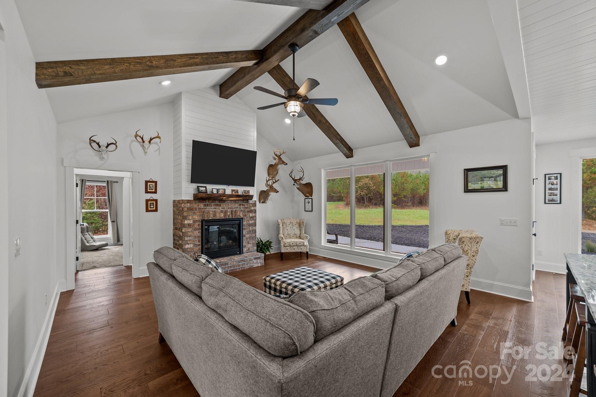 450 Bringle Ferry Road Denton, NC 27239 - Photo 15 of 48 a living room with fireplace furniture and a flat screen tv