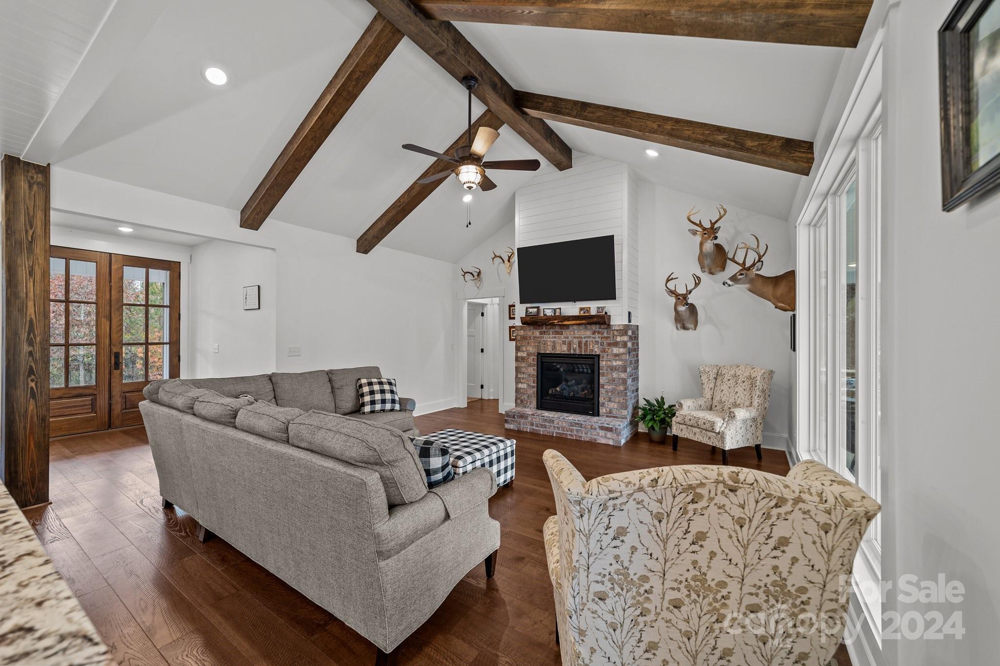 450 Bringle Ferry Road Denton, NC 27239 - Photo 18 of 48 a living room with furniture a fireplace and a flat screen tv