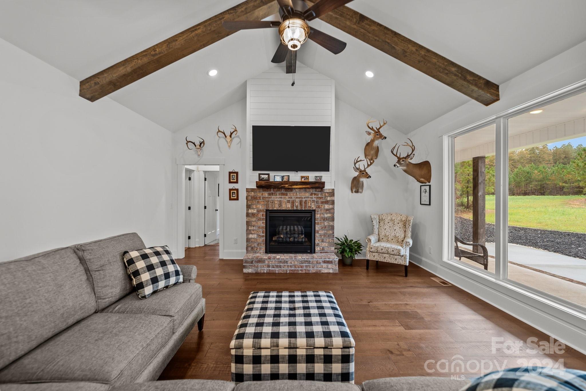 450 Bringle Ferry Road Denton, NC 27239 - Photo 19 of 48 a living room with furniture a flat screen tv and a fireplace