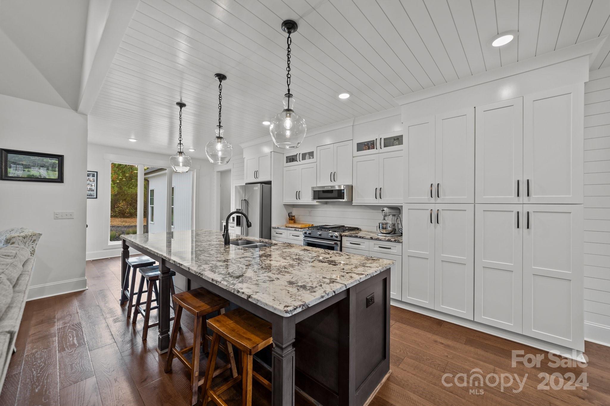 450 Bringle Ferry Road Denton, NC 27239 - Photo 20 of 48 a kitchen with cabinets table and chairs