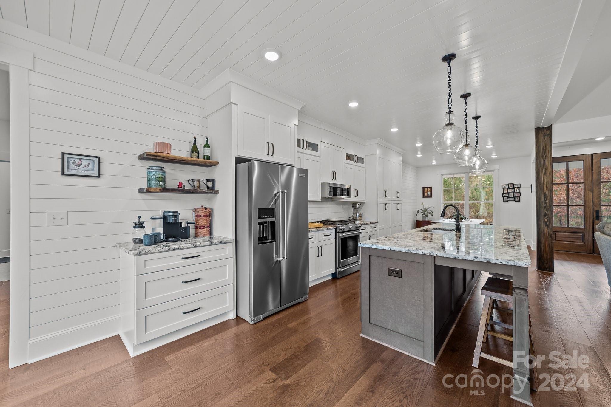 450 Bringle Ferry Road Denton, NC 27239 - Photo 22 of 48 a kitchen with stainless steel appliances kitchen island granite countertop a refrigerator and a stove top oven