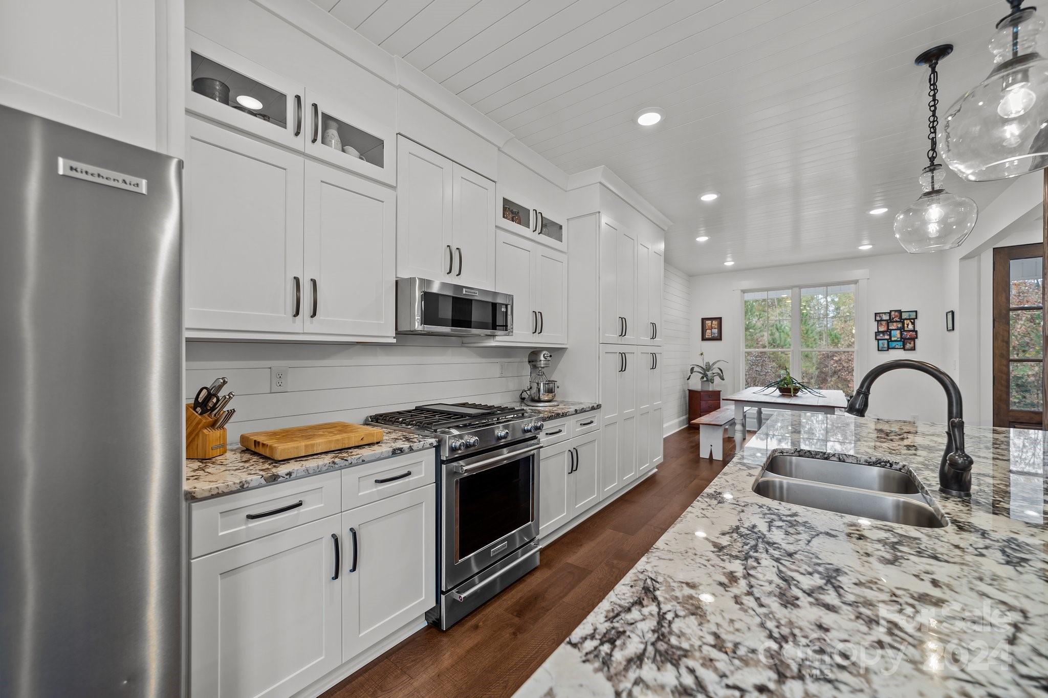 450 Bringle Ferry Road Denton, NC 27239 - Photo 25 of 48 a kitchen with stainless steel appliances granite countertop a stove a sink and a refrigerator