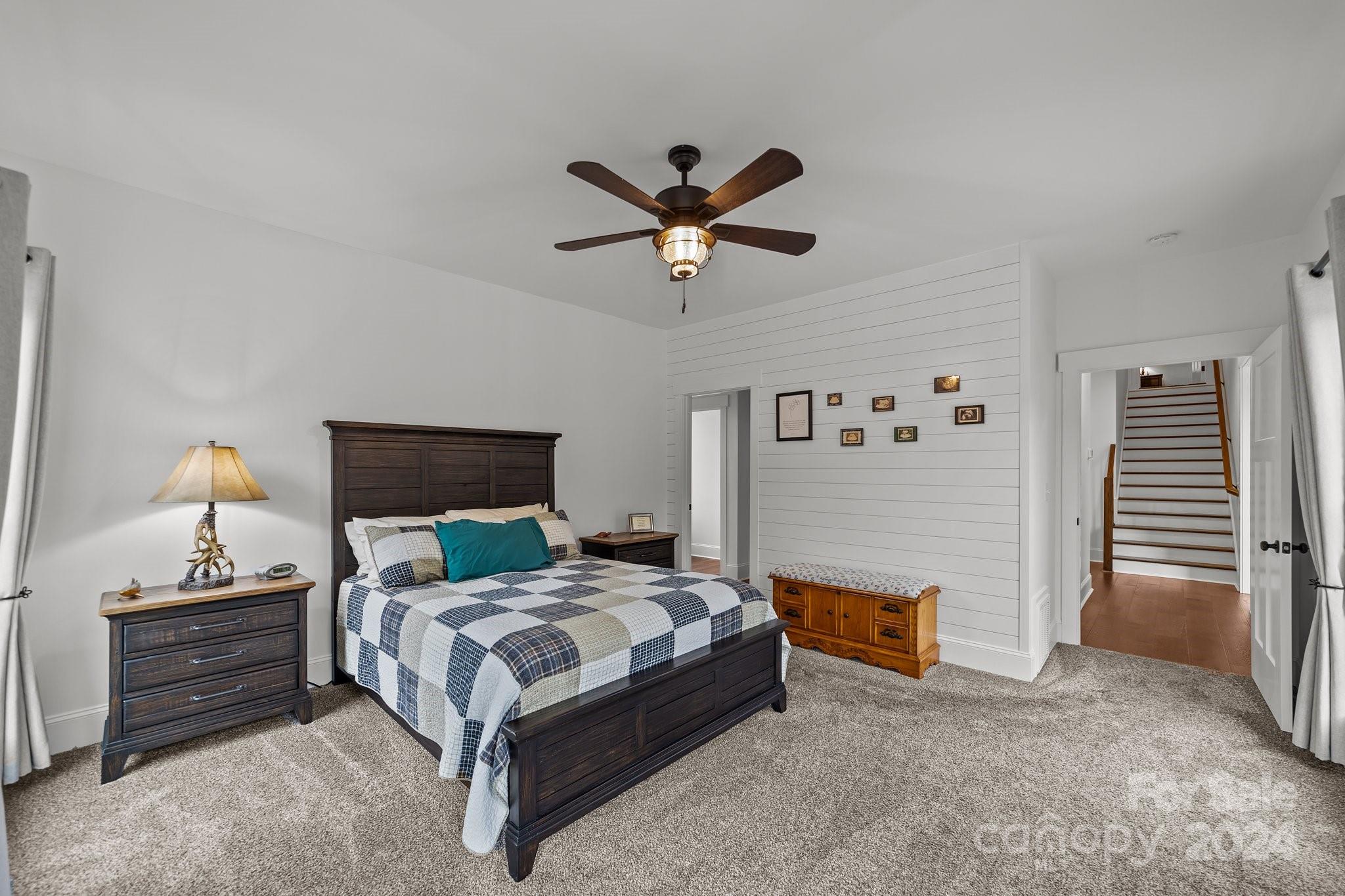 450 Bringle Ferry Road Denton, NC 27239 - Photo 29 of 48 a bedroom with a bed and a chandelier