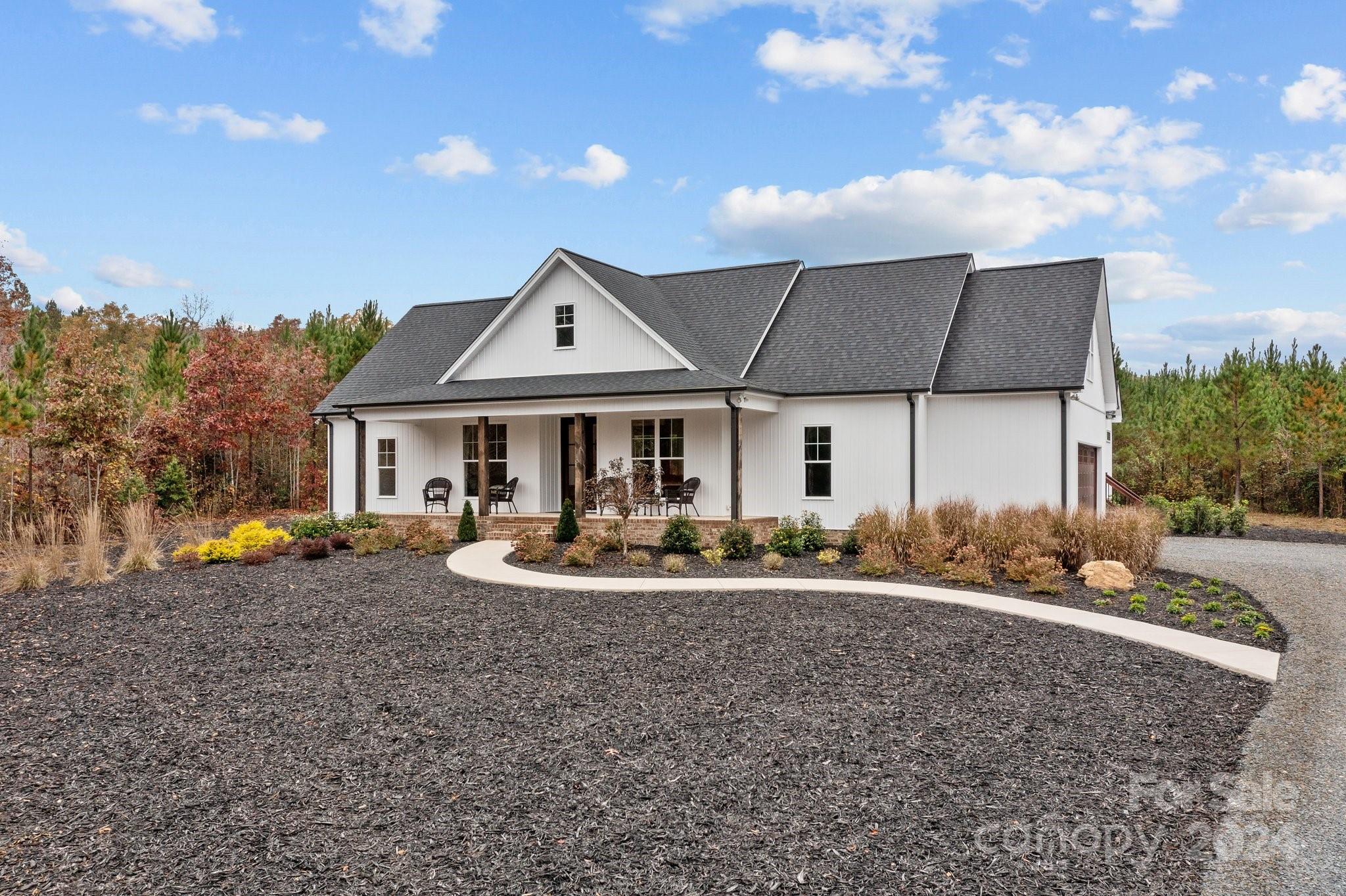 450 Bringle Ferry Road Denton, NC 27239 - Photo 3 of 48 a front view of house with yard porch and outdoor seating