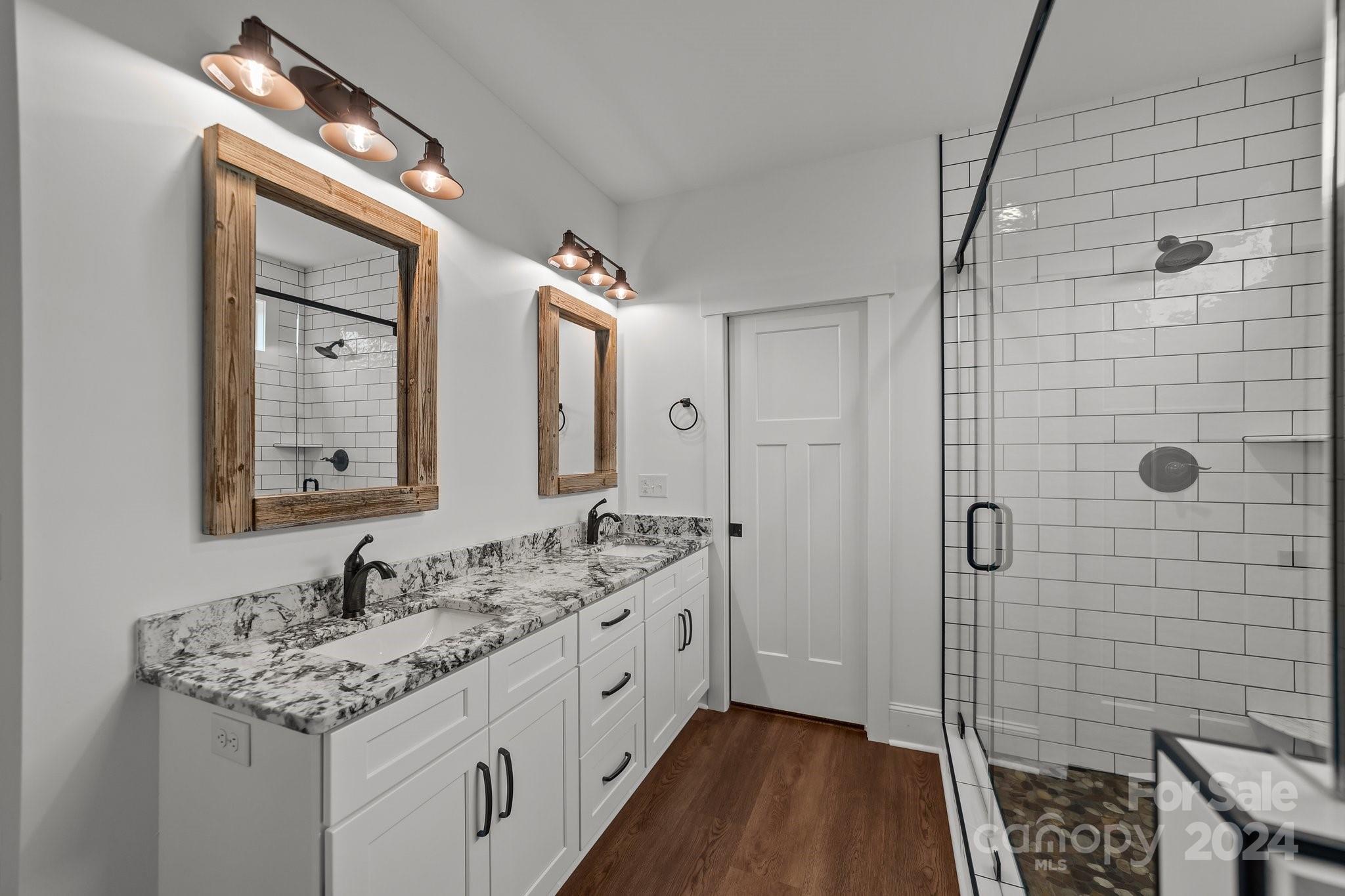 450 Bringle Ferry Road Denton, NC 27239 - Photo 31 of 48 a bathroom with a double vanity sink and a mirror