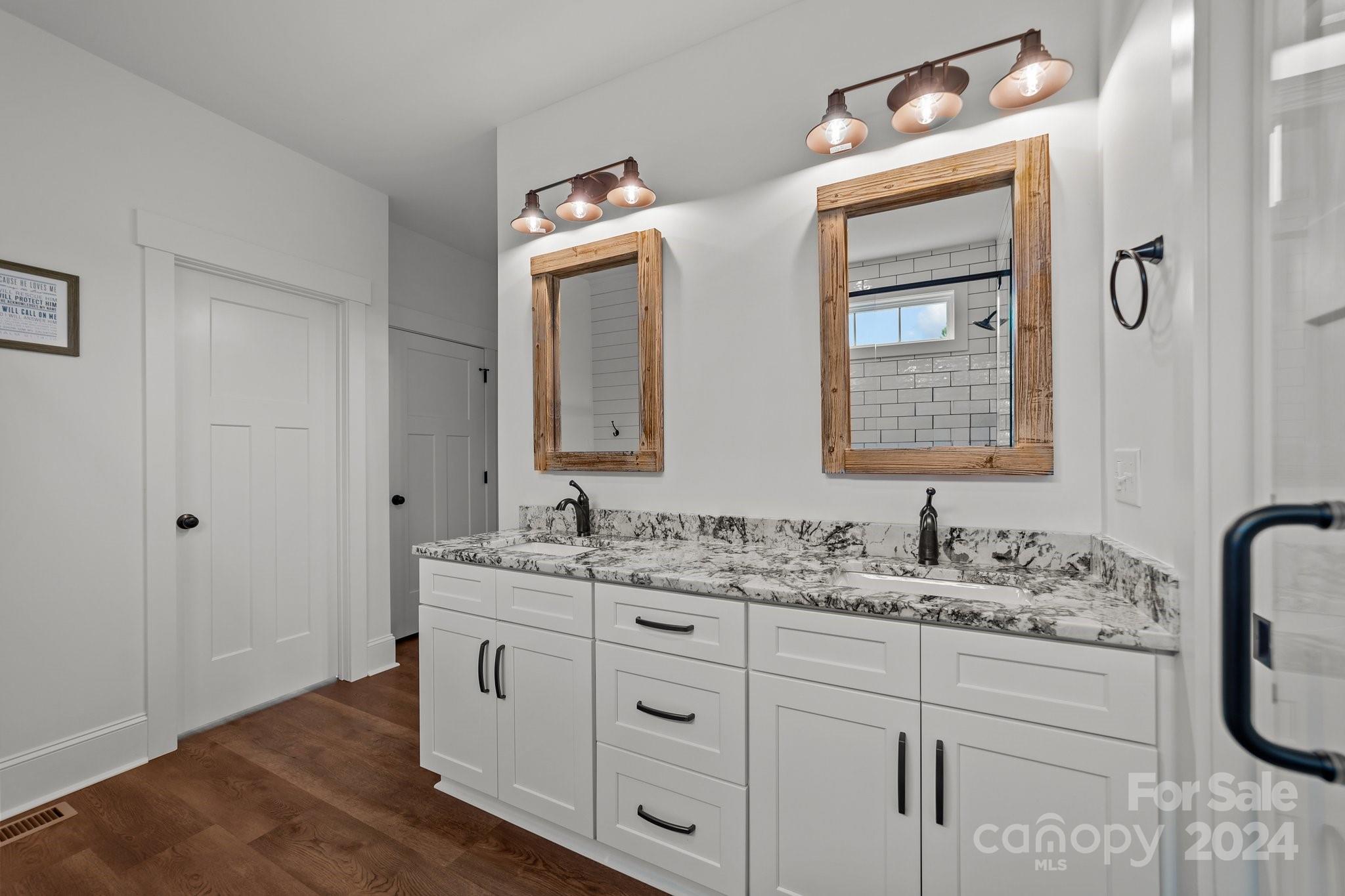 450 Bringle Ferry Road Denton, NC 27239 - Photo 33 of 48 a bathroom with double sink and a mirror
