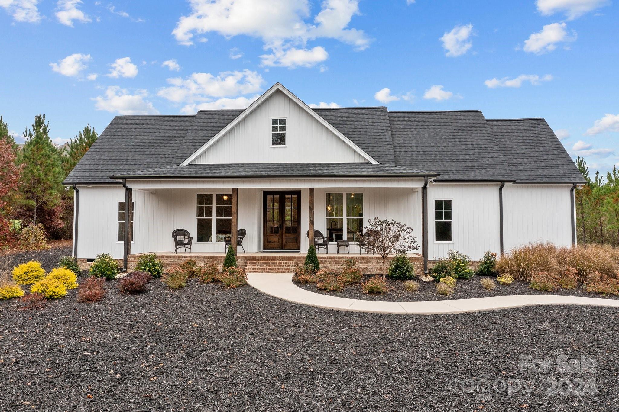 450 Bringle Ferry Road Denton, NC 27239 - Photo 4 of 48 a front view of a house with garden