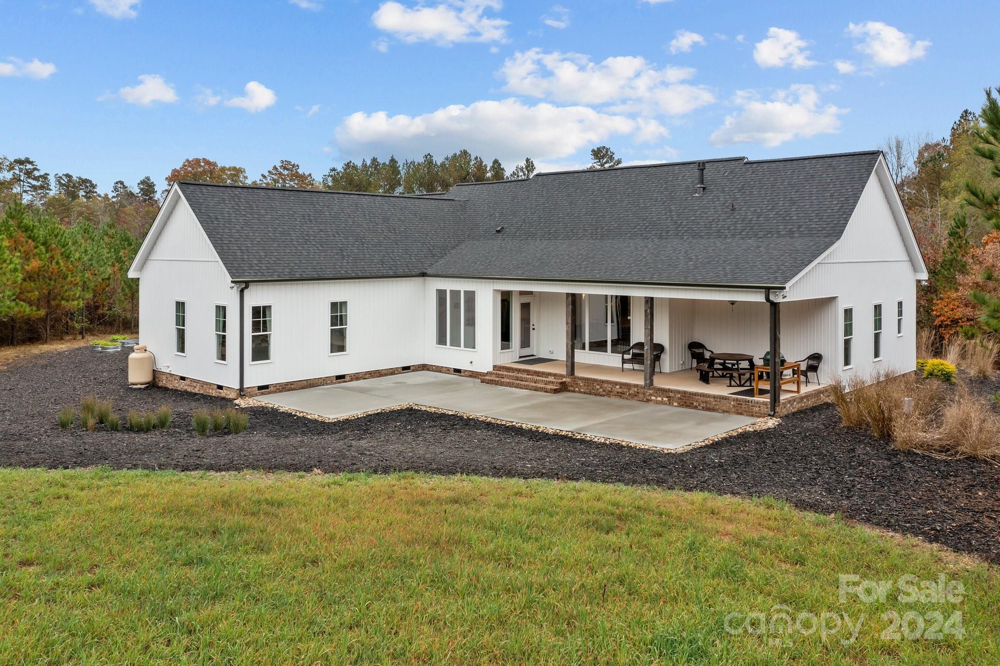 450 Bringle Ferry Road Denton, NC 27239 - Photo 43 of 48 a view of house with outdoor space and sitting area