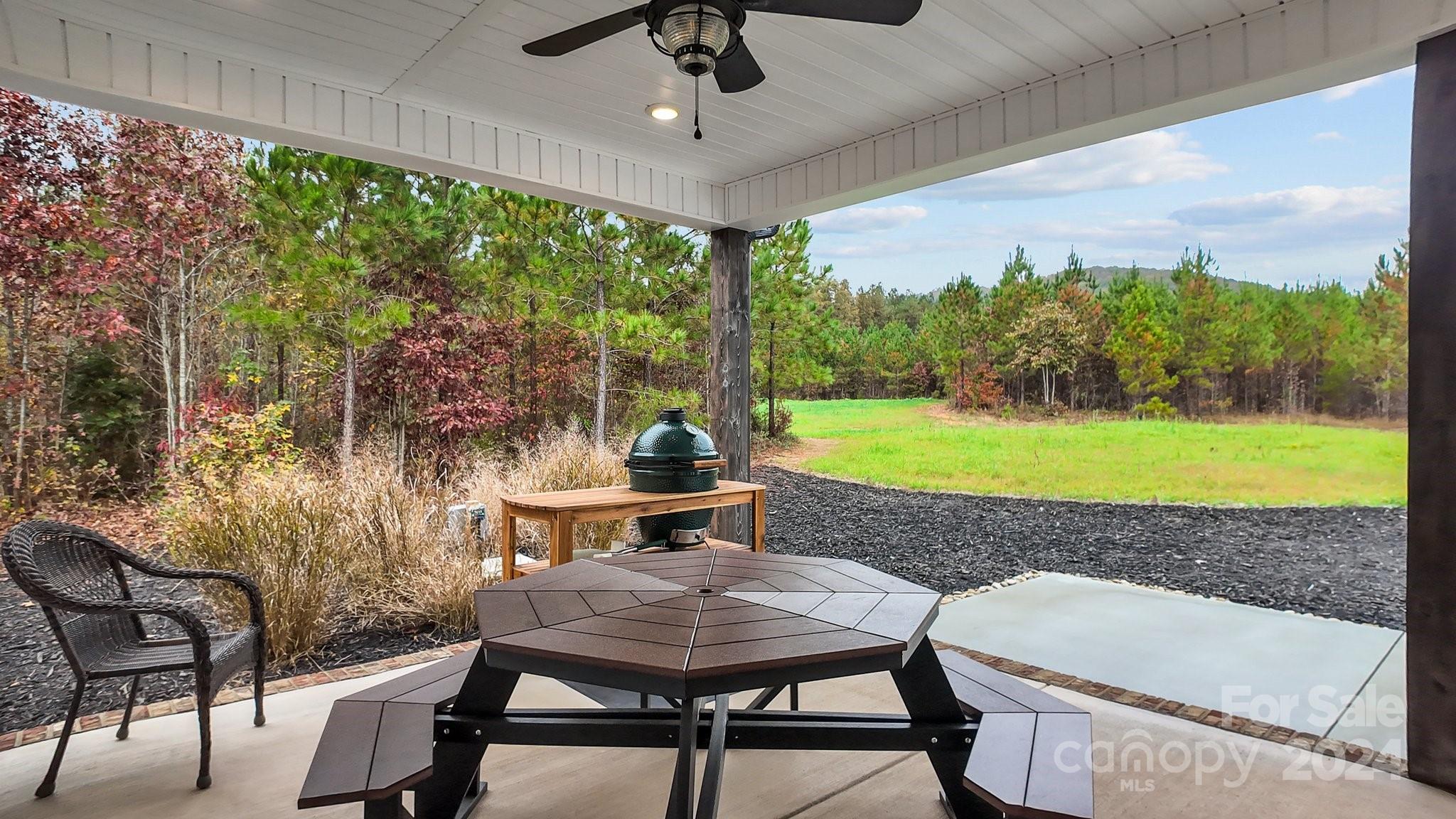 450 Bringle Ferry Road Denton, NC 27239 - Photo 45 of 48 a view of a patio with a table chairs and a backyard